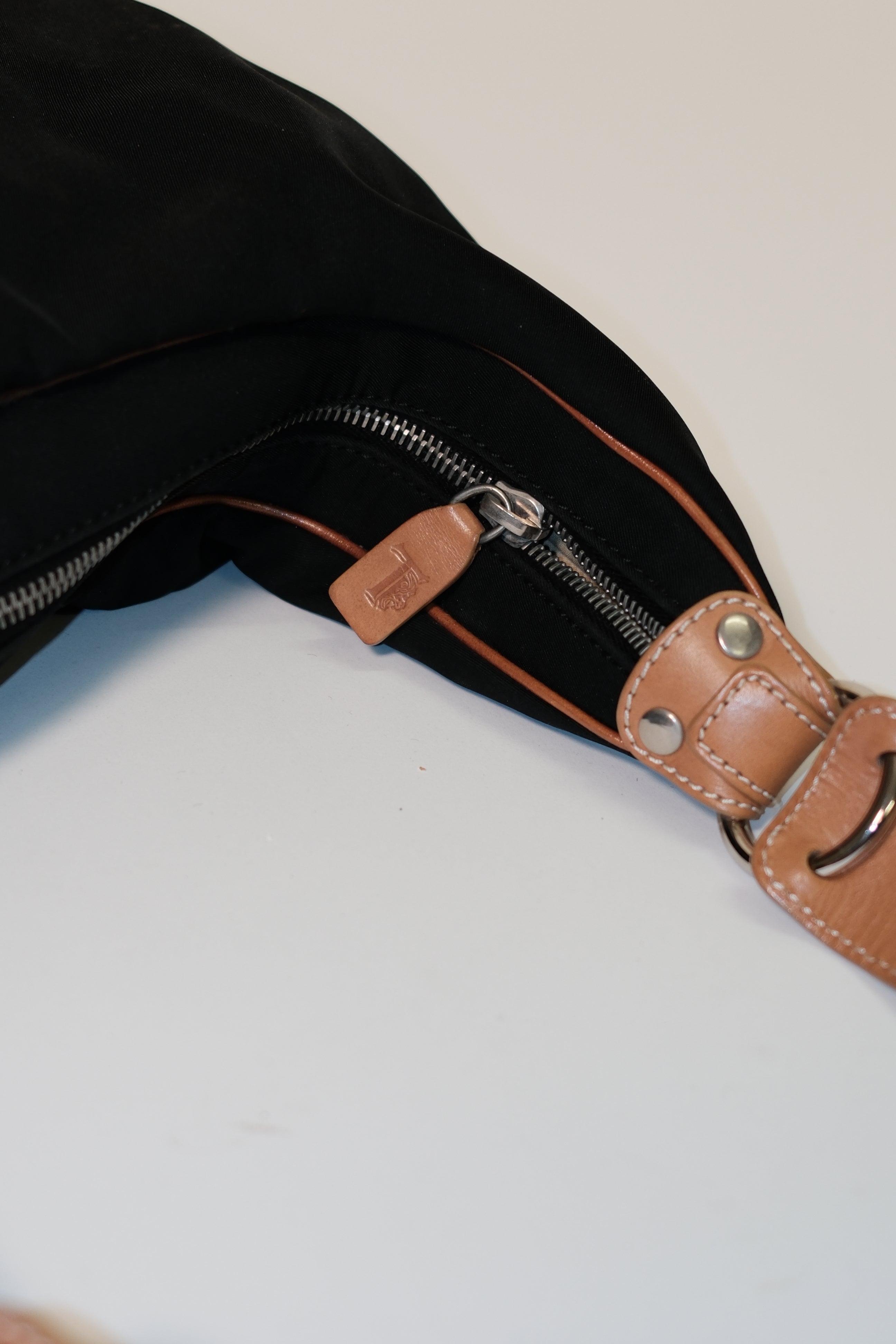 Tod's long strap cross body bag in black canvas and tan leather