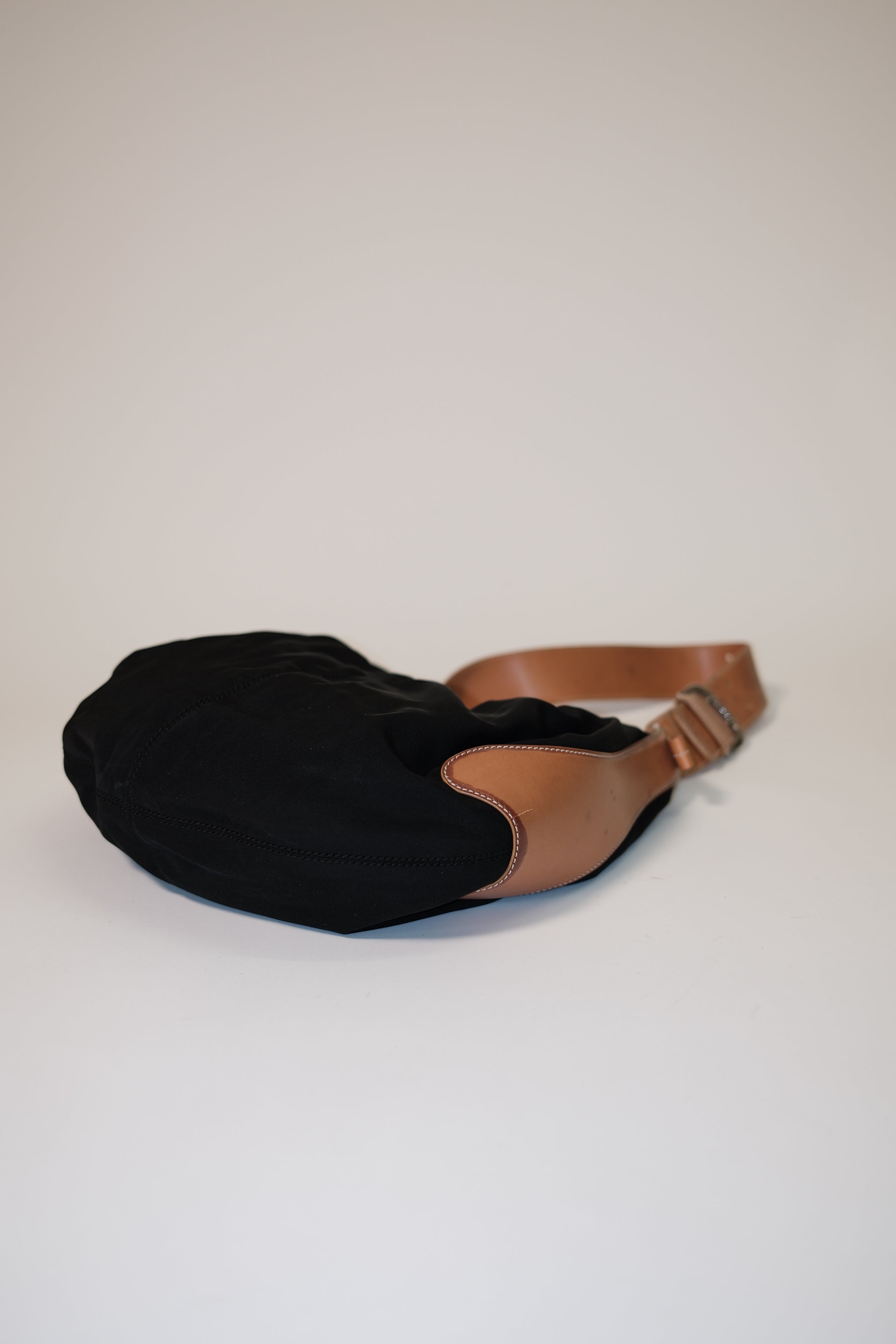 Tod's long strap cross body bag in black canvas and tan leather