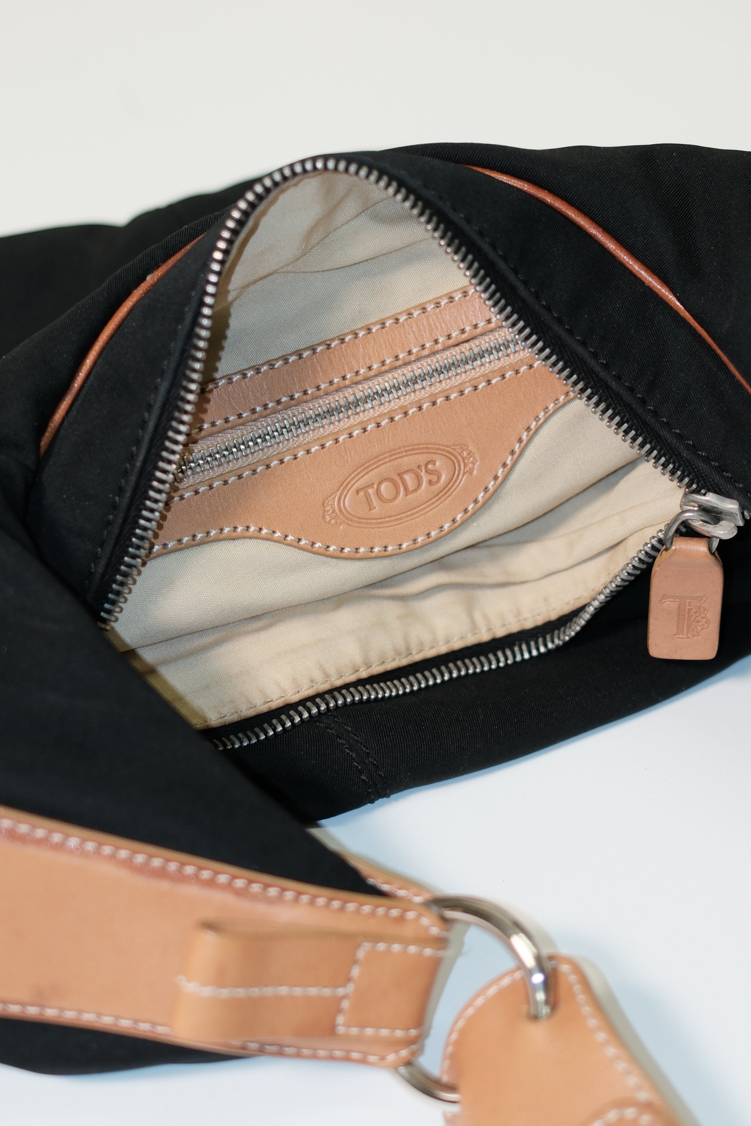 Tod's long strap cross body bag in black canvas and tan leather