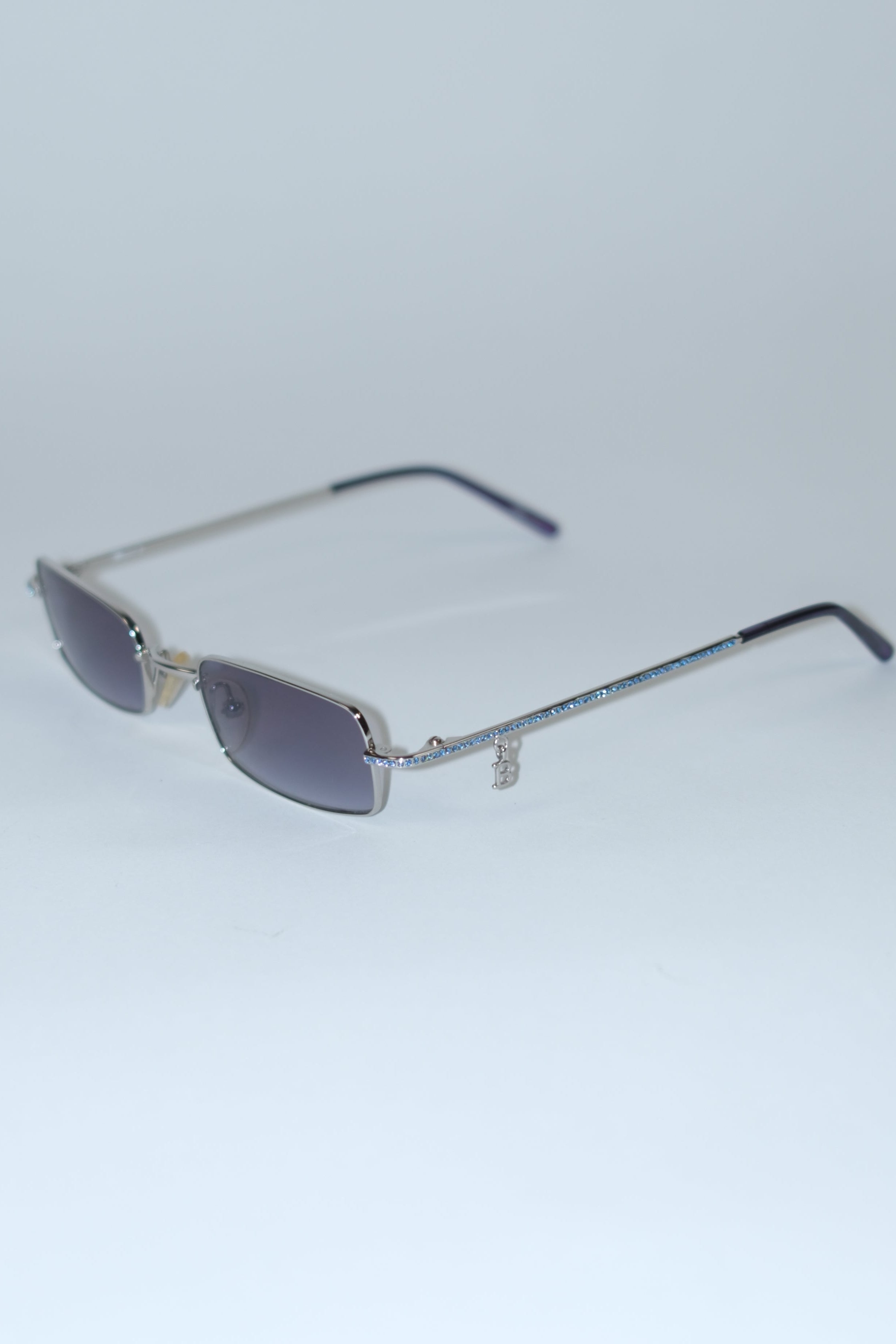 BLUMARINE NARROW SUNGLASSES WITH BLUE LENSES BLUE RHINESTONES AND LOGO PIERCING DETAIL
