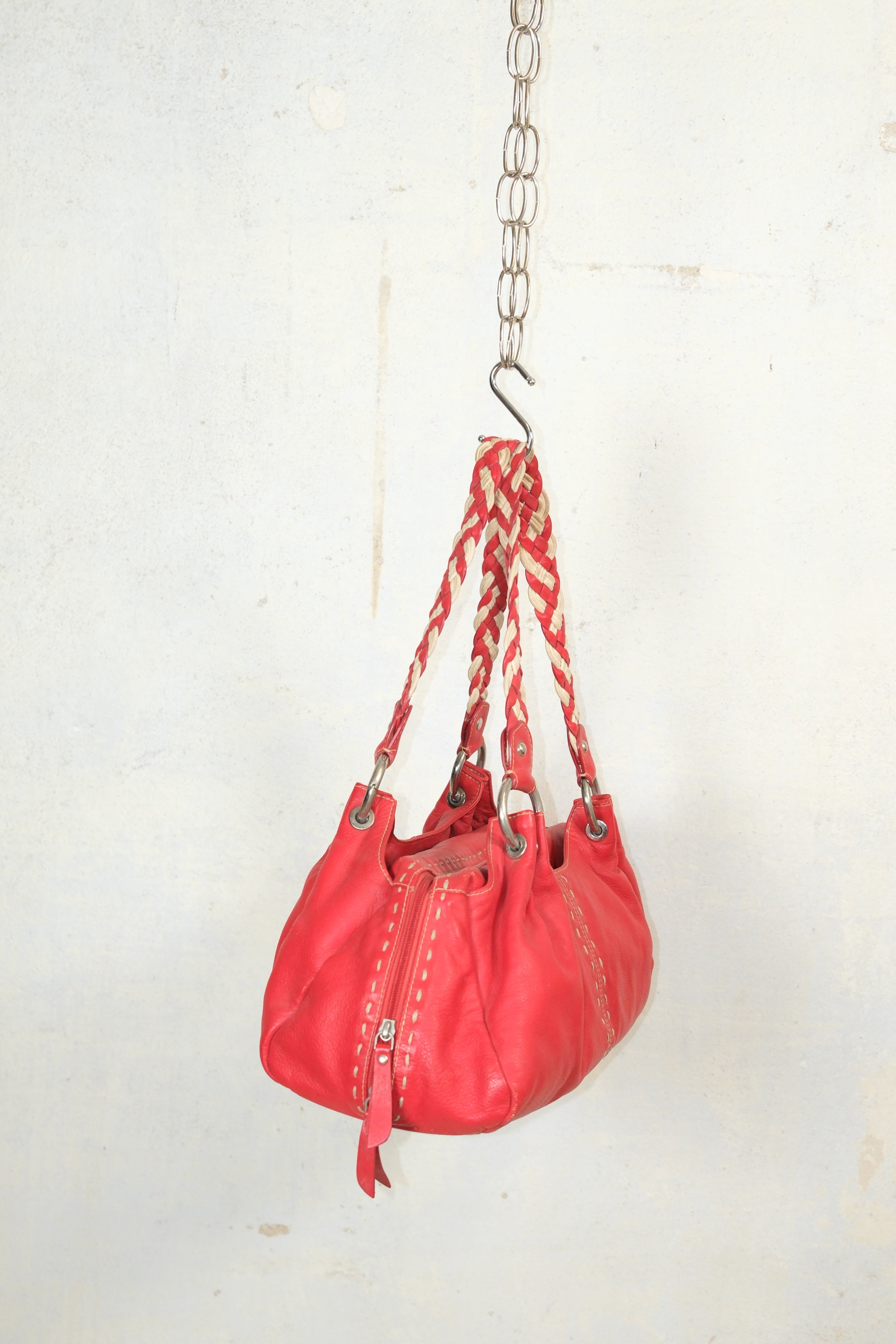 RED LEATHER BAG FEATURING WHITE STITCHING & BRAIDED HANDLES