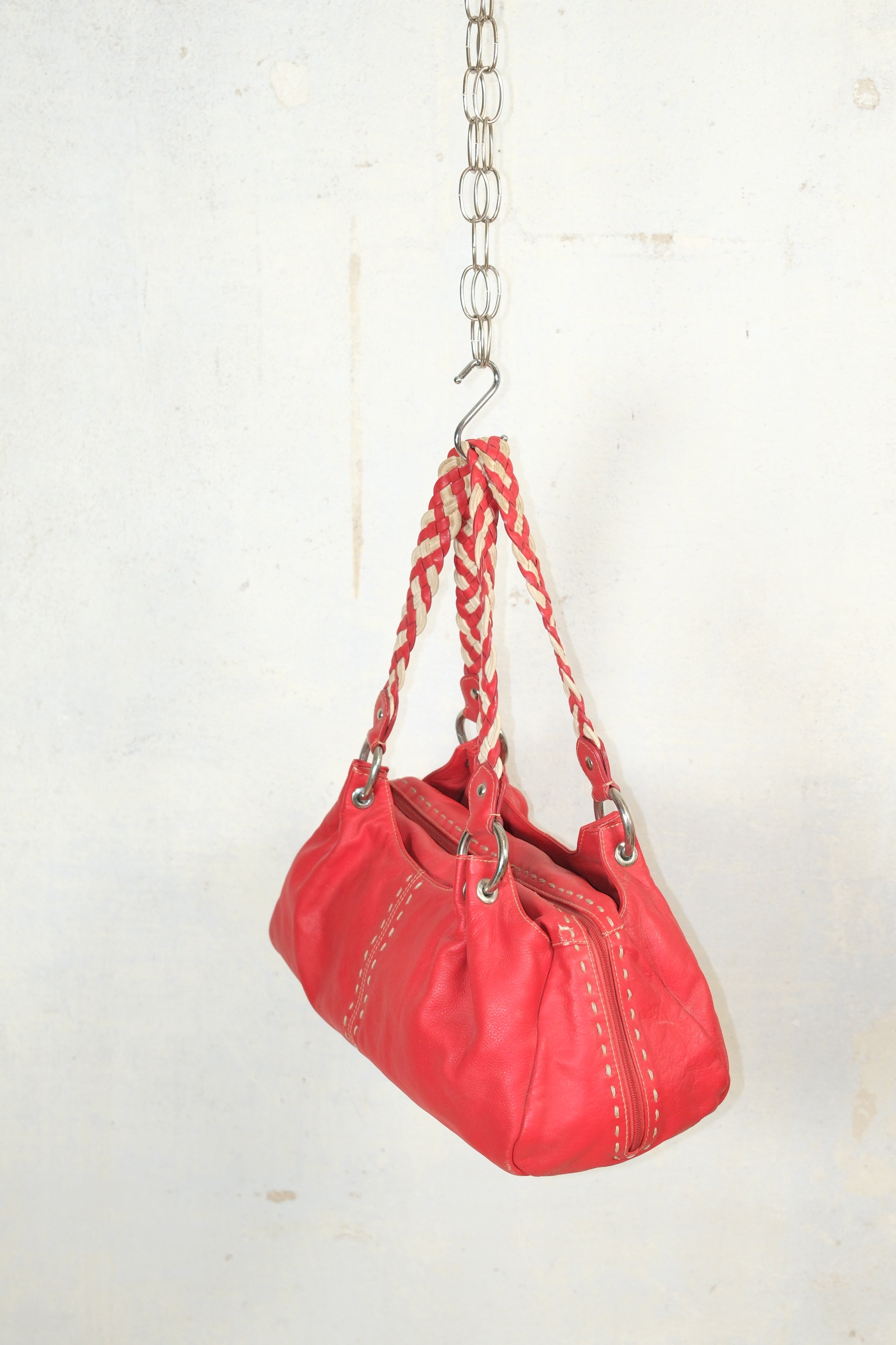 RED LEATHER BAG FEATURING WHITE STITCHING & BRAIDED HANDLES