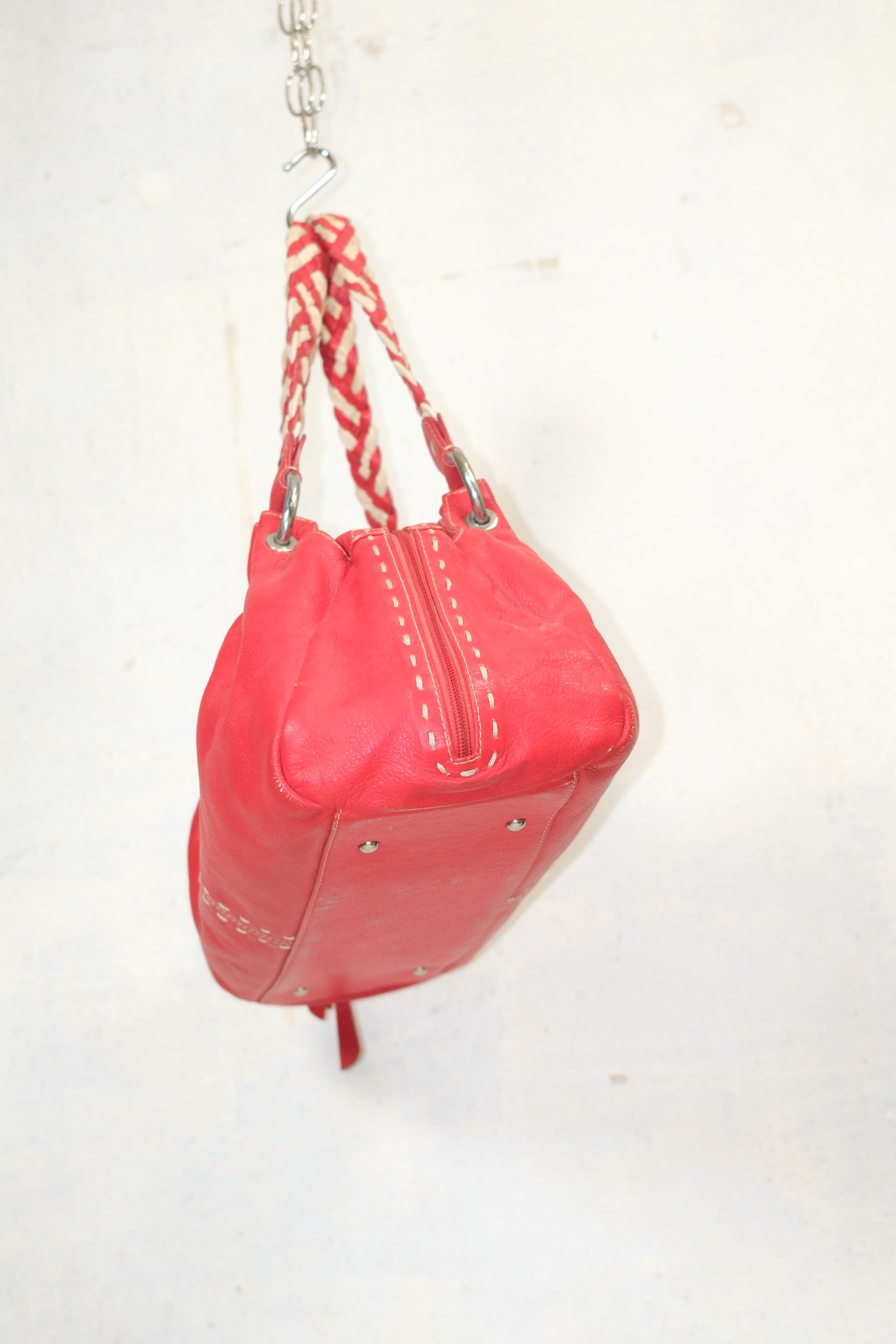 RED LEATHER BAG FEATURING WHITE STITCHING & BRAIDED HANDLES