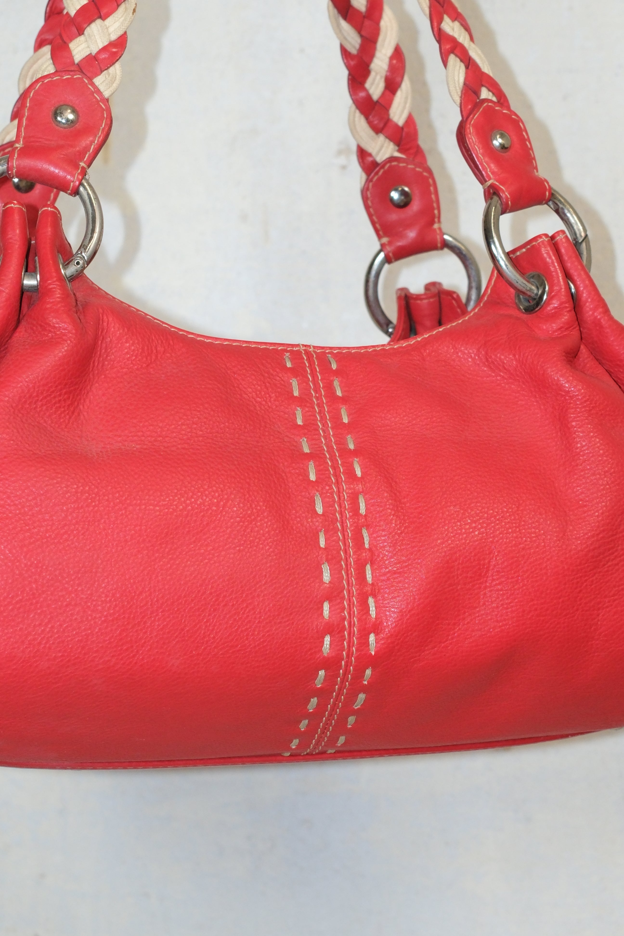 RED LEATHER BAG FEATURING WHITE STITCHING & BRAIDED HANDLES