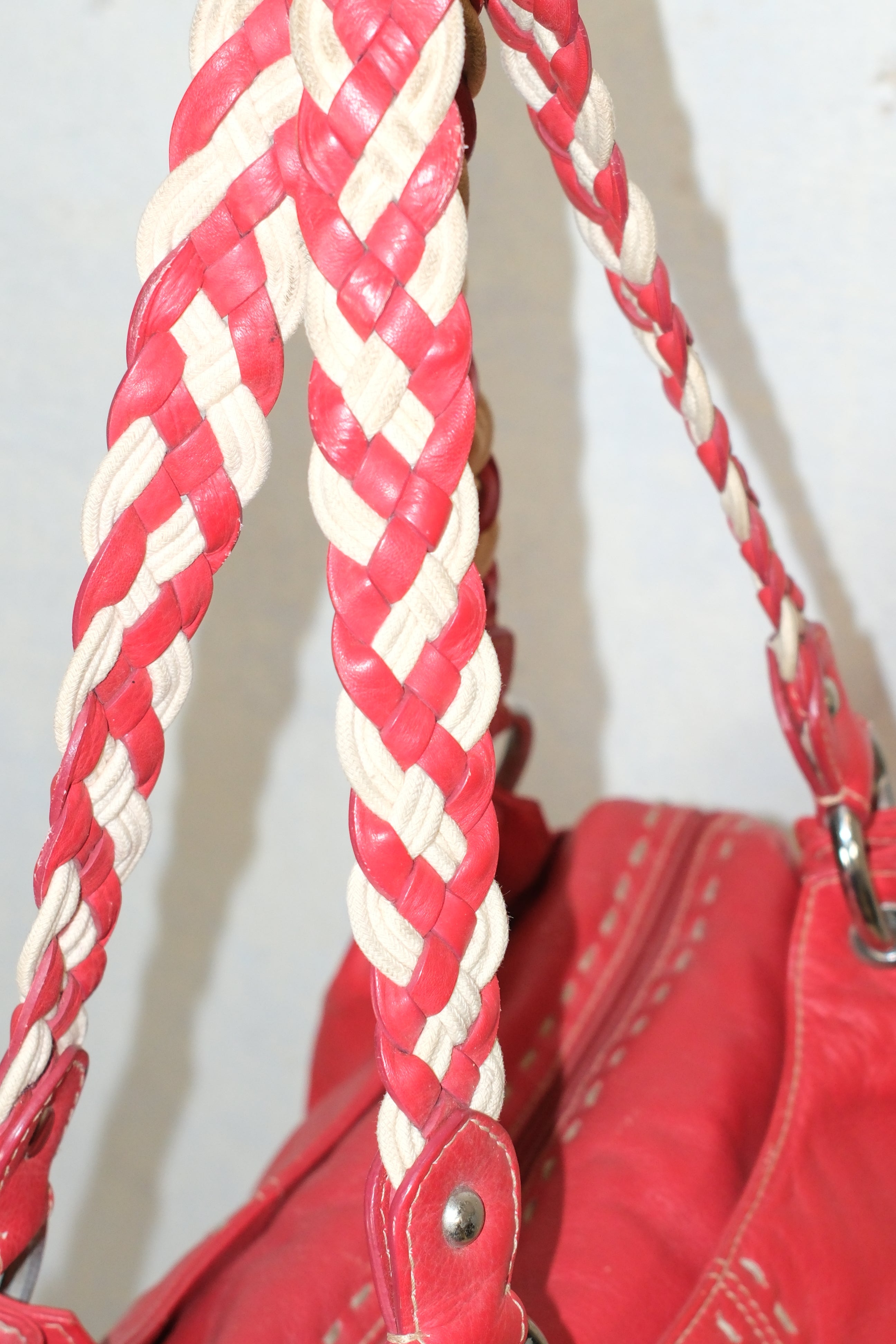 RED LEATHER BAG FEATURING WHITE STITCHING & BRAIDED HANDLES