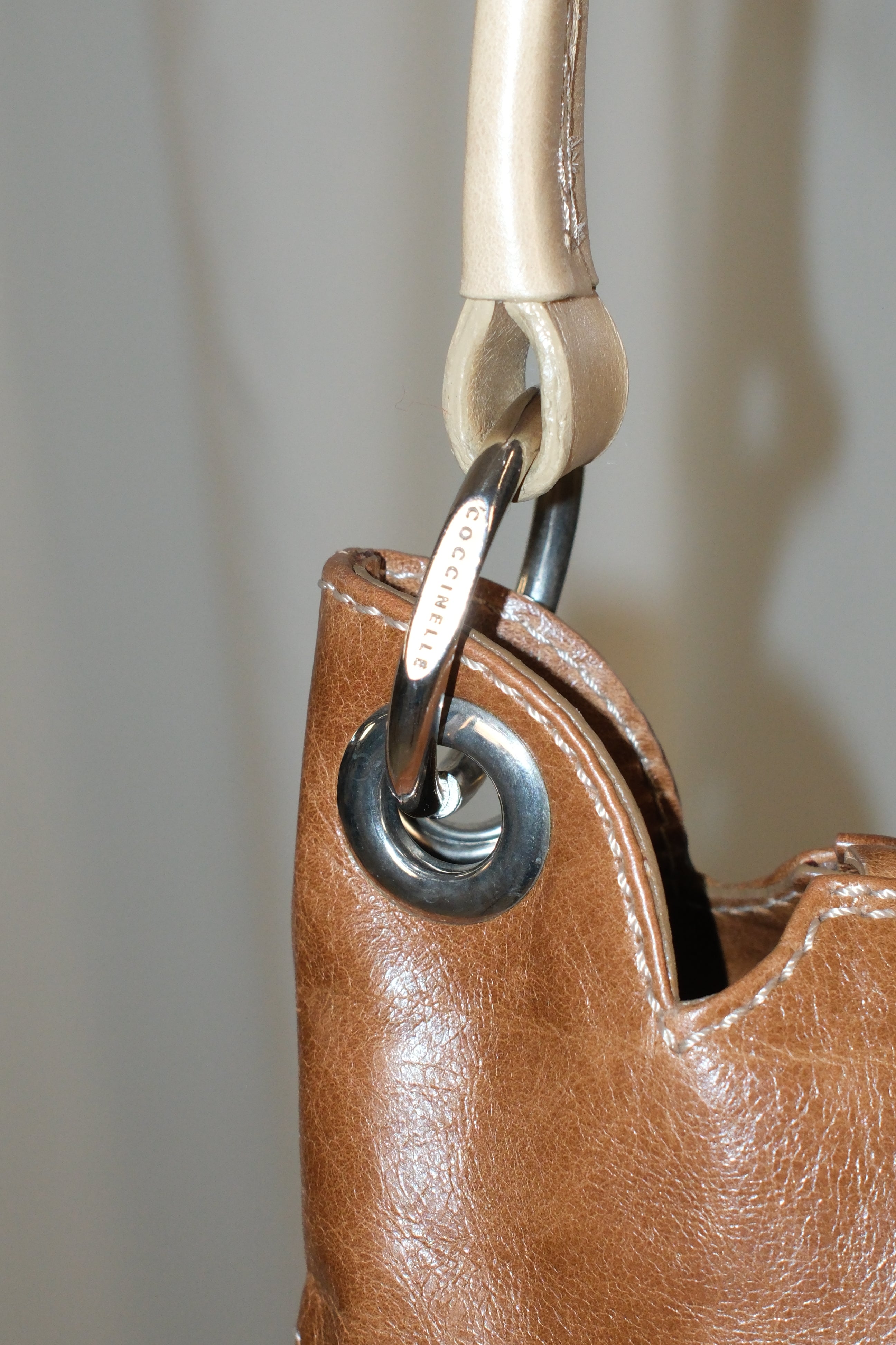 Coccinelle brown leather bag with cream stiff handle