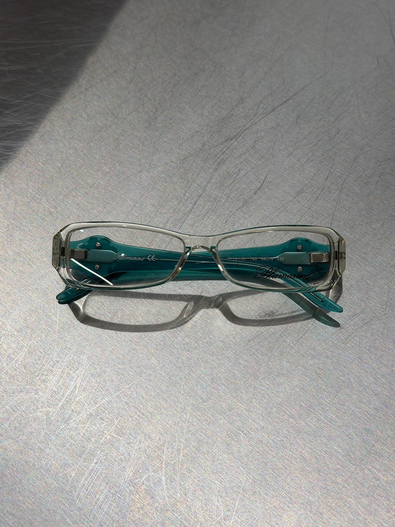 BLUMARINE TRANSPARENT GLASSES WITH AQUA TURQUOISE TEMPLES AND LARGE RHINESTONE DETAIL