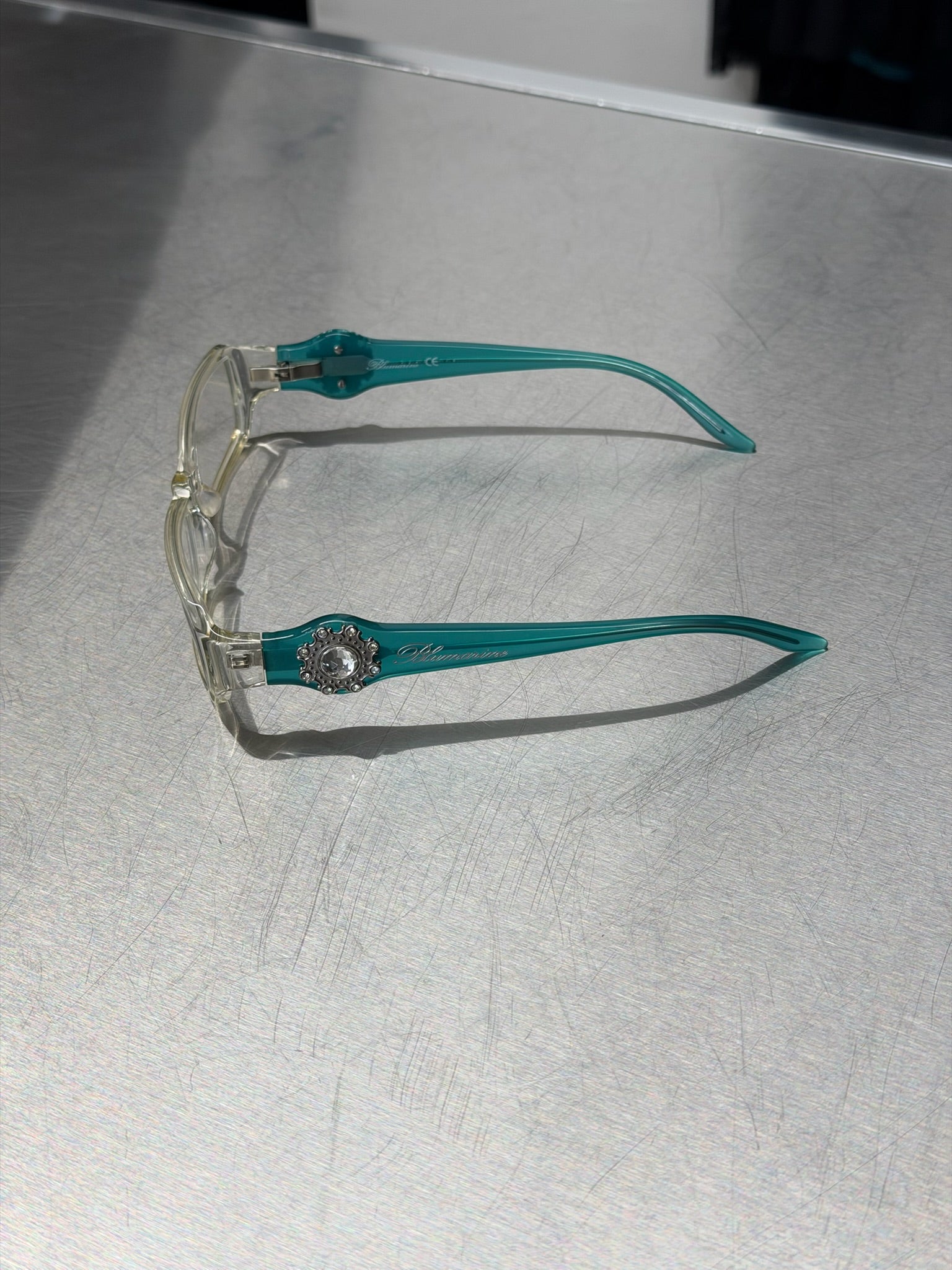 BLUMARINE TRANSPARENT GLASSES WITH AQUA TURQUOISE TEMPLES AND LARGE RHINESTONE DETAIL